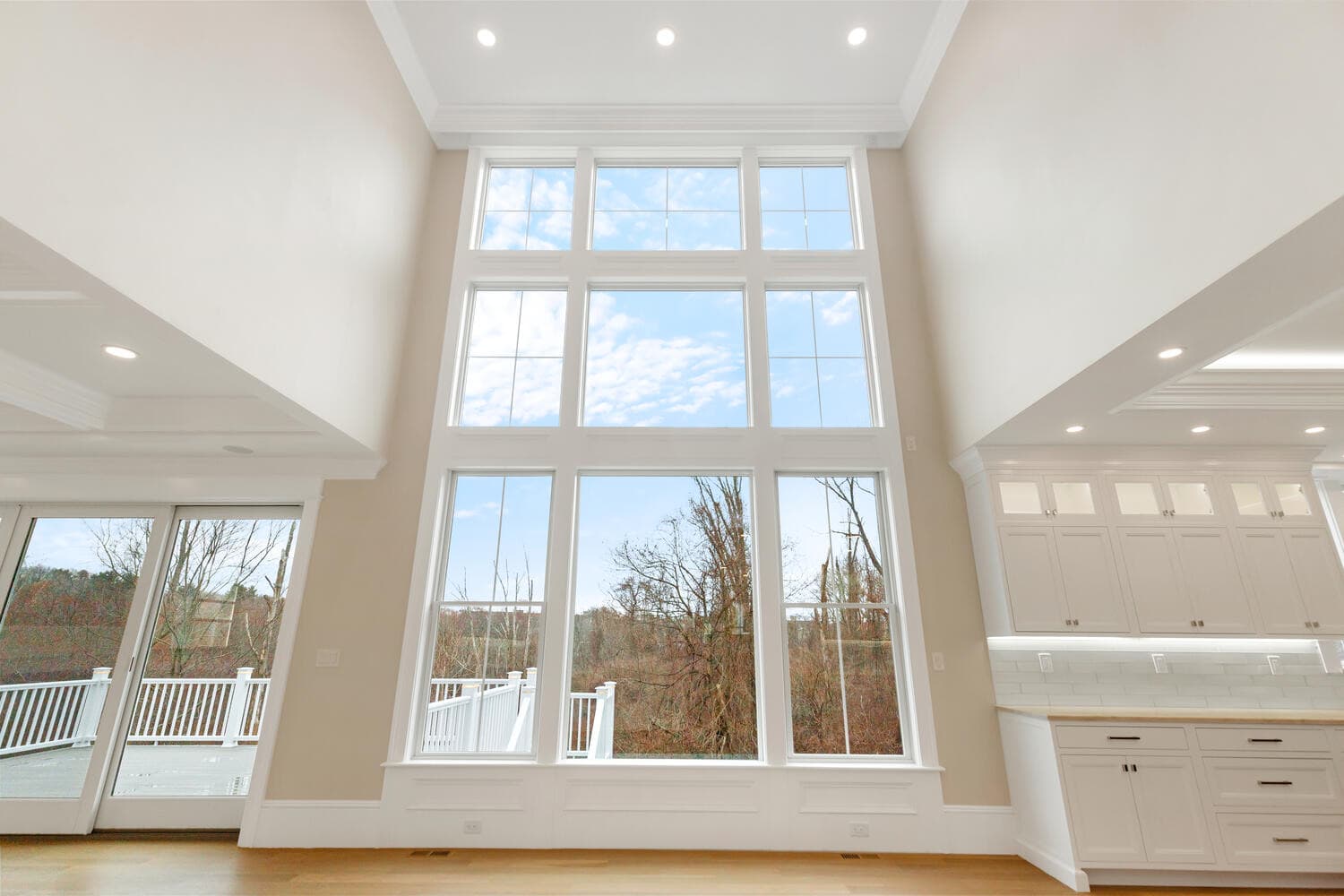 Great room with floor-to-ceiling Andersen windows and sky views