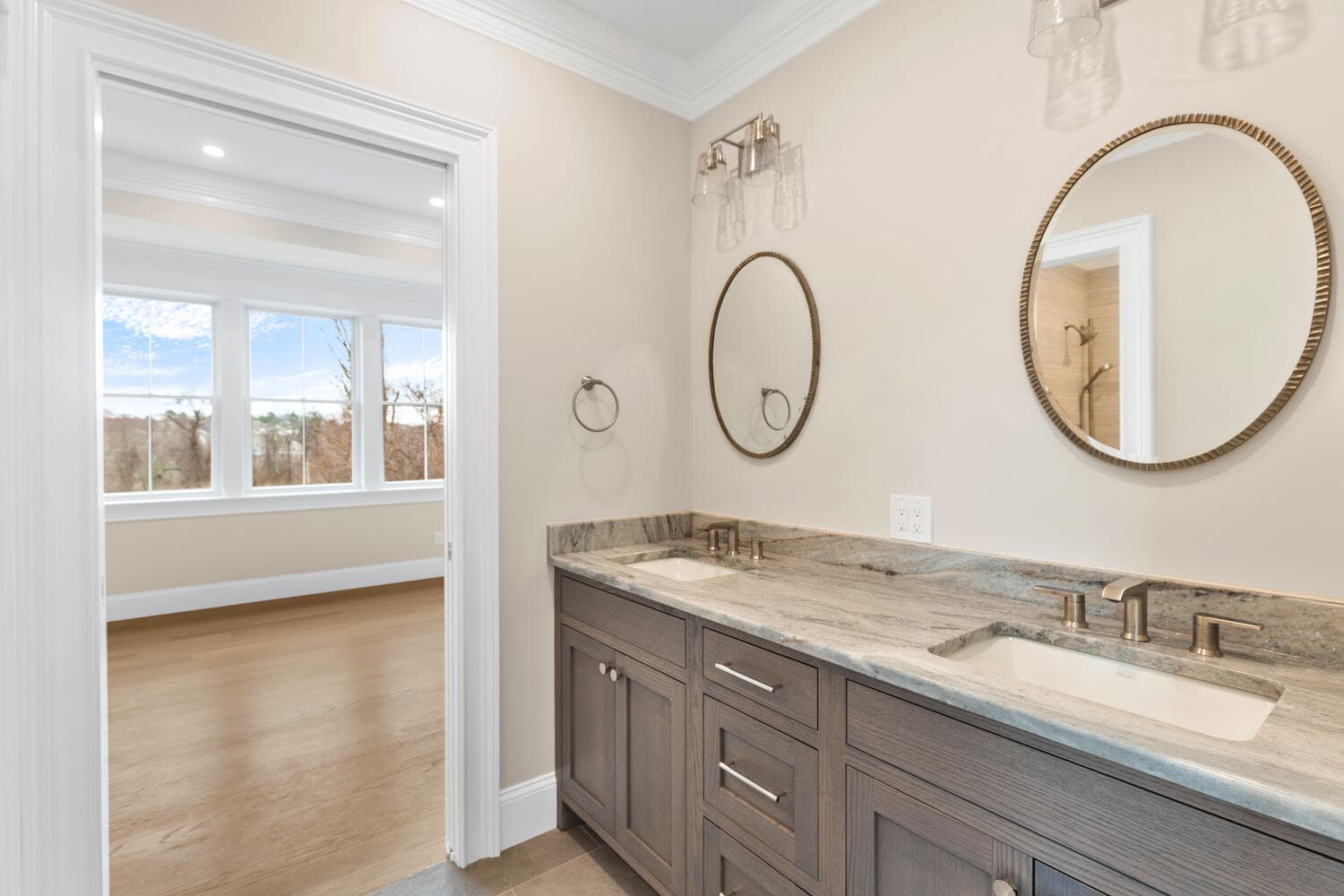 Jack and Jill bathroom with dual vanity and marble countertops