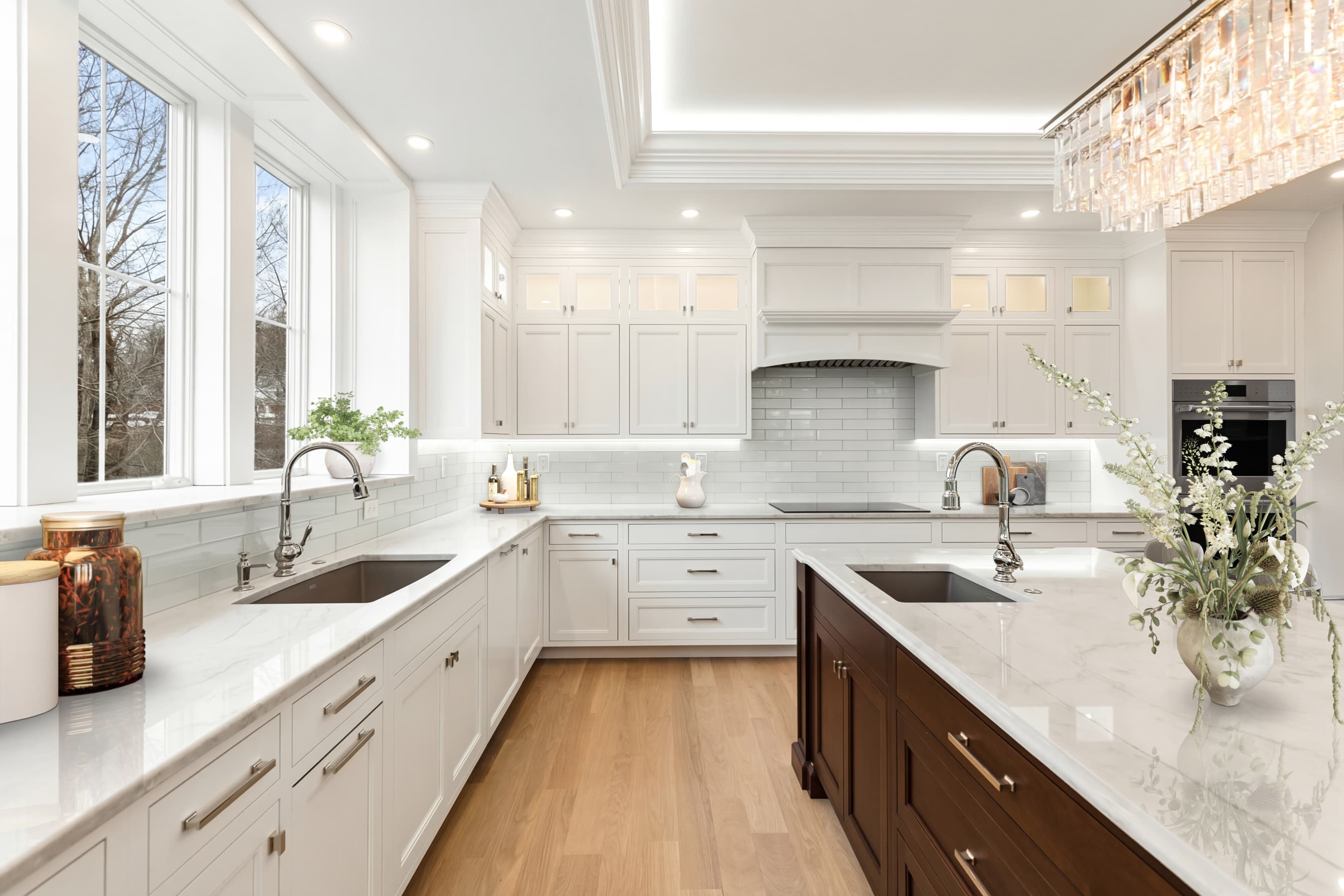 Kitchen with white cabinetry, natural light, and marble counters — virtually staged