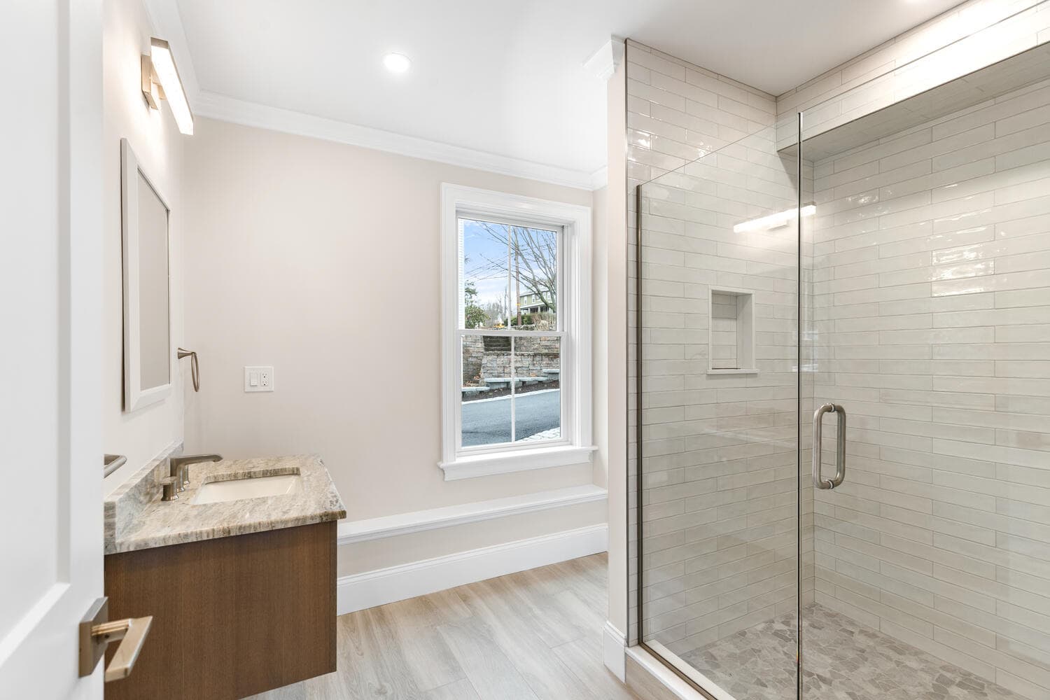 Lower level full bathroom with floating vanity and tile shower
