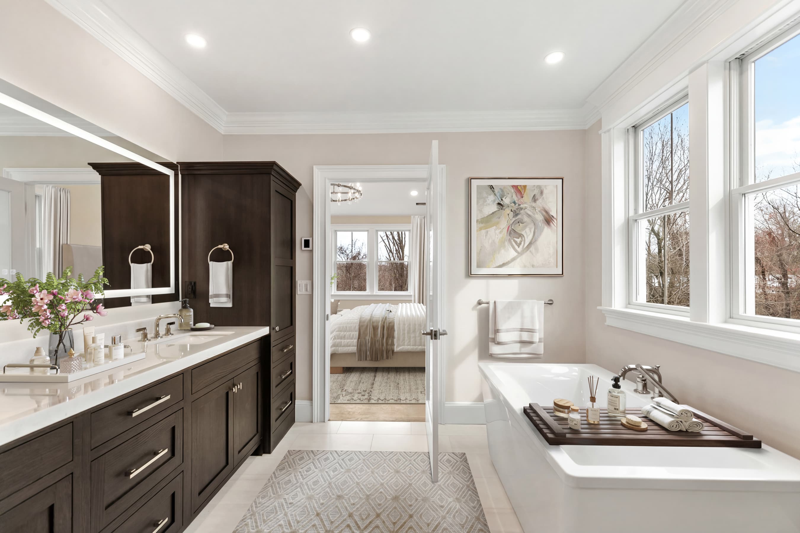 Primary spa bath with dark wood vanity, soaking tub, and artwork — virtually staged